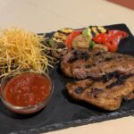 Стейк зi свинини з картоплею по-селянски та овочами гриль